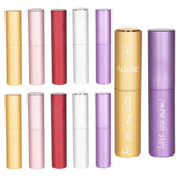 A collection of colorful cylindrical Portable 8ml Atomiser Perfume Spray Bottles by CrealityFalcon, ideal for personalized laser engraved gifts. They come in shades of gold, red, pink, white, silver, and purple. Some bottles feature inscriptions: "Adelle," "For you! my sister," and "Love you mom!" with a butterfly symbol near "Adelle." Perfect laser engraving ideas!