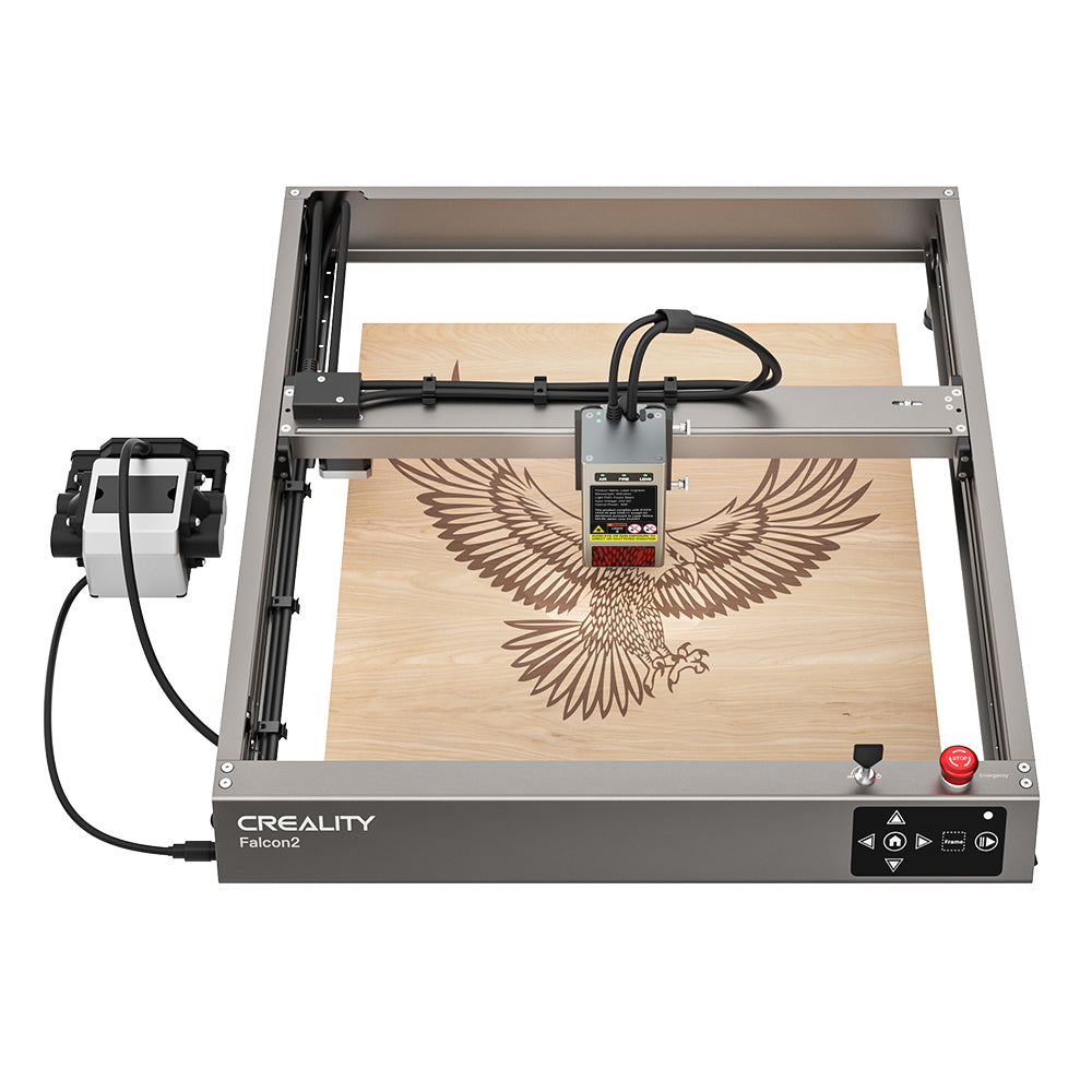 The image shows a CrealityFalcon Falcon2 12W Laser Engraver and Cutter. The machine has intricately etched an eagle with outstretched wings on a wooden surface. The equipment includes a control box and wiring connected to the laser head.