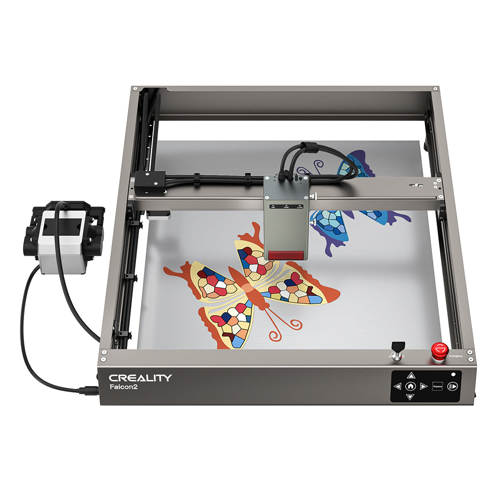 A 3D printer with the label "CrealityFalcon Falcon2 40W Laser Engraver and Cutter" is laser-printing a colorful butterfly design. The frame, resembling a high-end laser engraver, is metallic with various control buttons on one side and a connected external module. The butterfly design features mosaic-like details.