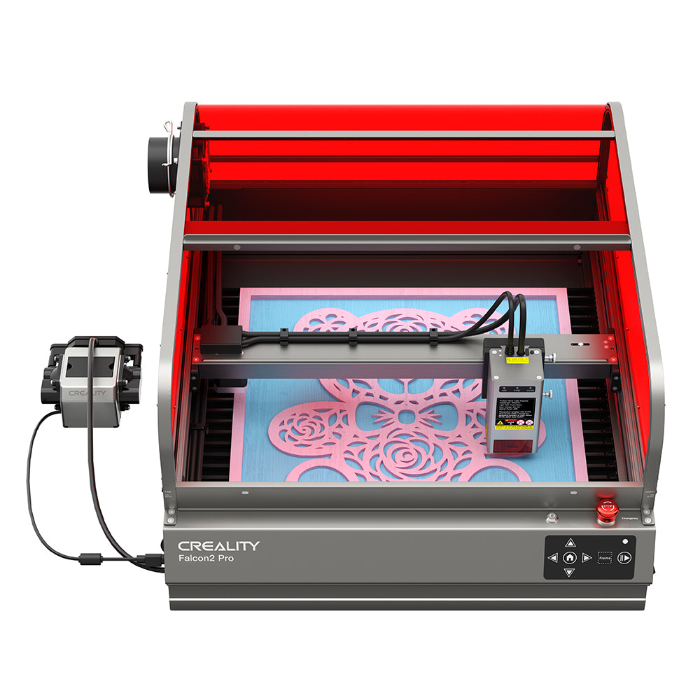 The CrealityFalcon Falcon2 Pro 22W/40W Enclosed Laser Engraver and Cutter is actively printing a detailed design. The machine has a red protective enclosure, a control panel at the front, and a power supply box connected to the left side, ensuring precise positioning and FDA Class 1 safety standards.