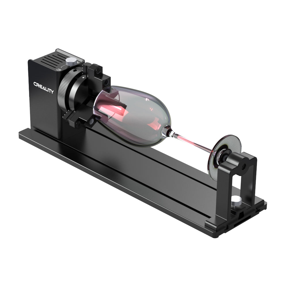 A black Rotary Kit Pro for Curved Surface Engraving with a sleek design, featuring a rotating mechanism and ball fixture mounted on a flat base. The device boasts the brand name "CrealityFalcon" on one side and is designed for high precision engraving on cylindrical objects, with multifunctional adjustable jaws for versatility.