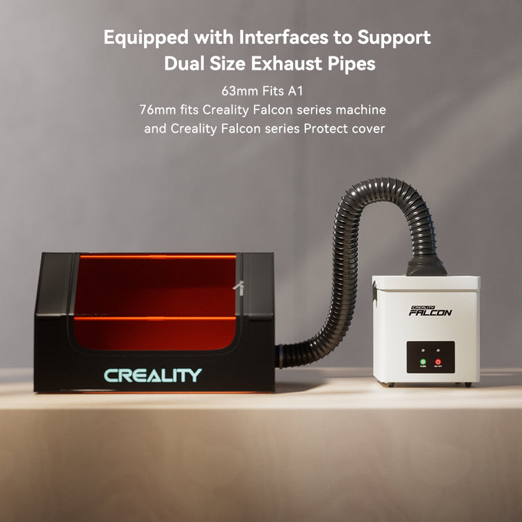 The CrealityFalcon Desktop Smoke Purifier for Falcon A1, featuring a transparent chamber and flexible hose attached to a white unit on a beige surface, supports dual-size exhaust pipes.
