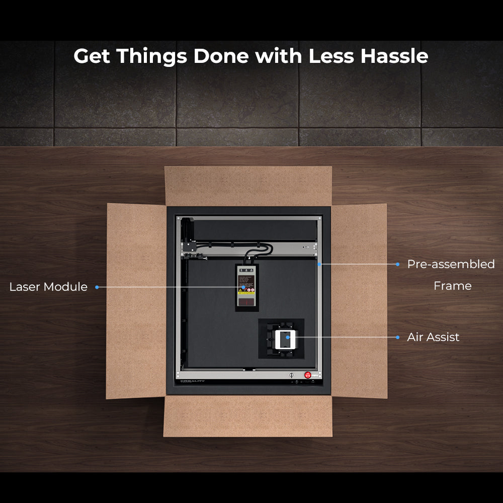 A top-down view of an open cardboard box on a wooden surface containing components of the CrealityFalcon Falcon2 40W Laser Engraver and Cutter with labels pointing to the powerful 40W laser module, pre-assembled frame, and air assist. The text "Get Things Done with Less Hassle" is displayed at the top.