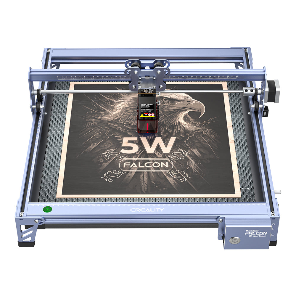 The CR-Laser Falcon 5W Laser Engraver by CrealityFalcon, renowned for its ultra-fine engraving accuracy, etches a detailed image of an eagle with "5W FALCON" text onto a wooden board. The machine features a robust blue metal frame and a control module positioned above the larger engraving area.